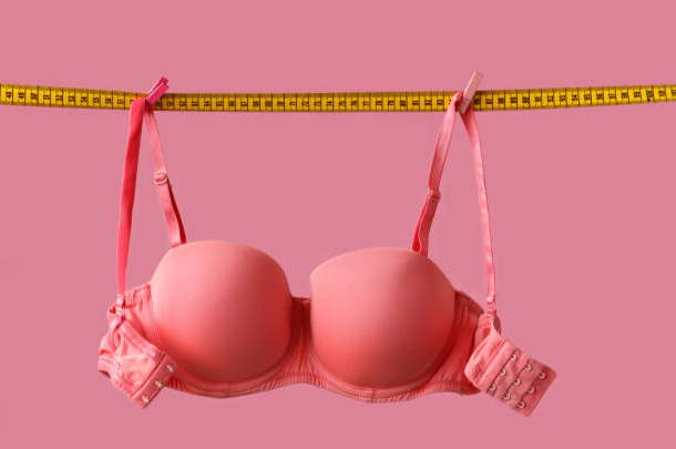 A bra with measuring tape holding it up