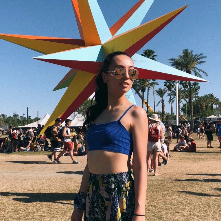 Carolyn B. at a festival in a blue crop top