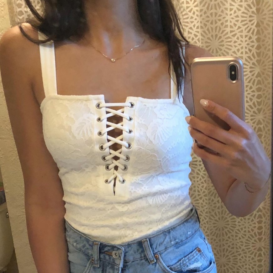 NC in a white lace-up top
